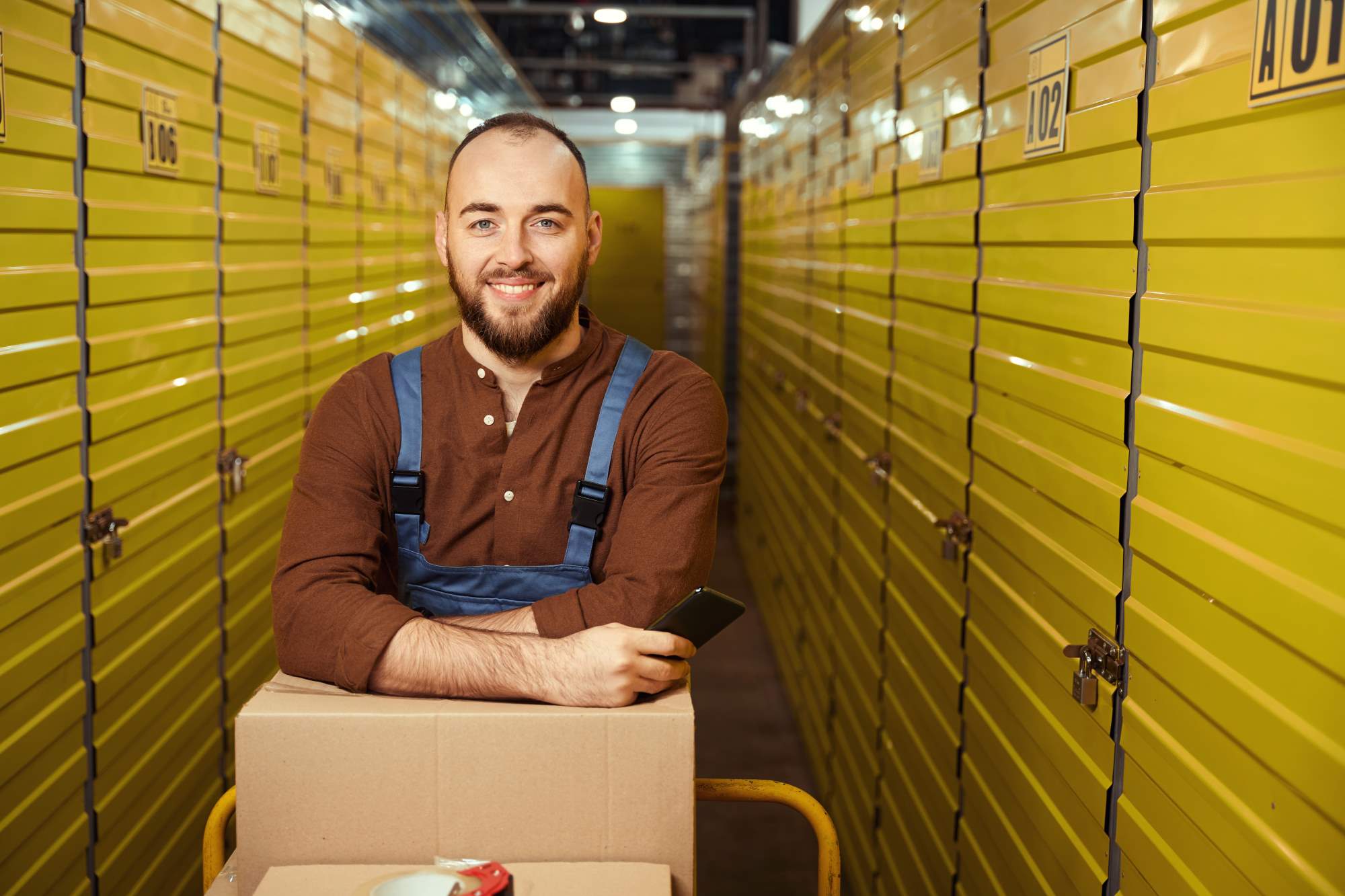 handsome-man-leaning-on-boxes-in-the-warehouse-2024-10-20-08-56-28-utc (2) | Best Dubai Storage self storage in dubai
