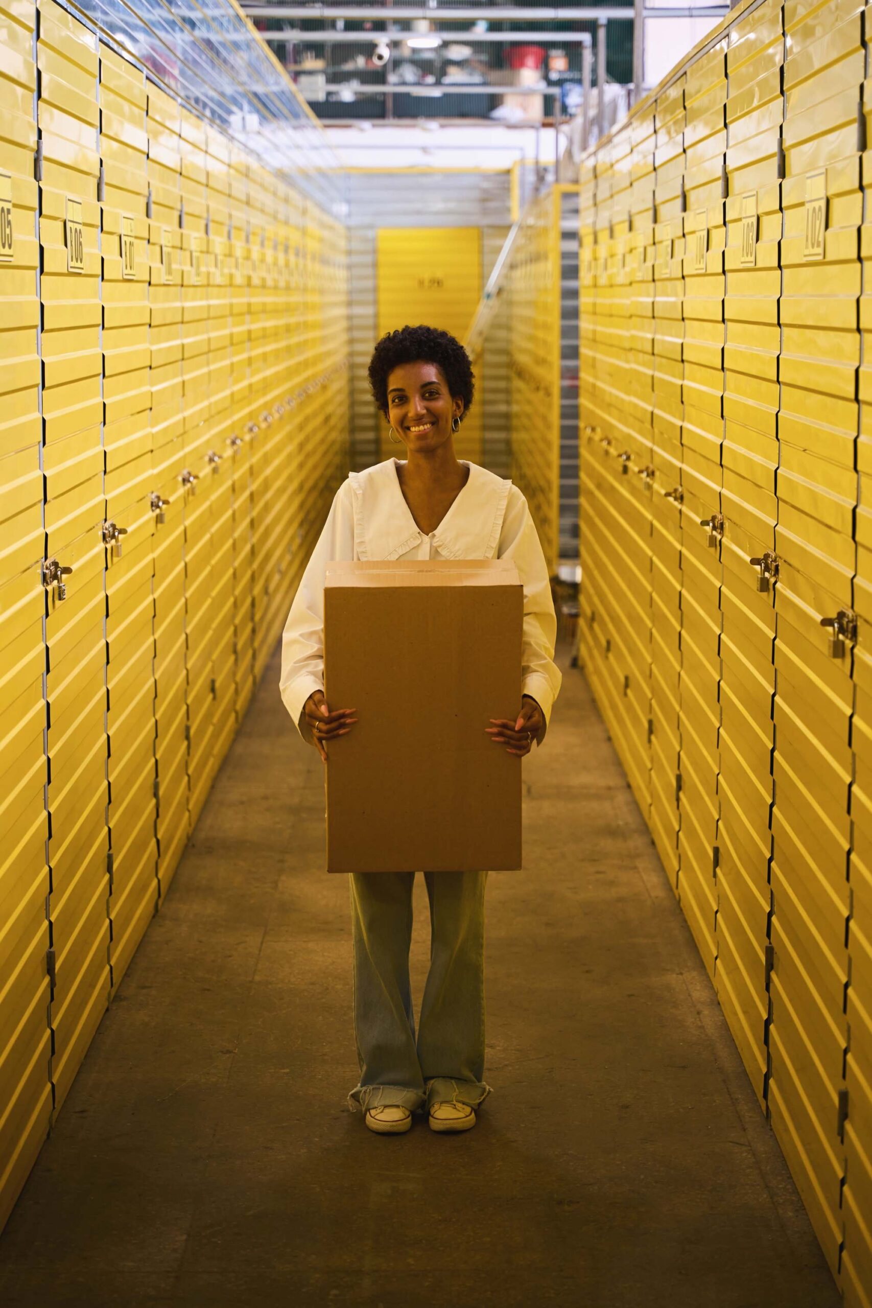 happy-young-woman-standing-in-warehouse-with-cardb-2024-10-22-04-11-44-utc (2) | Best Dubai Storage best dubai storage